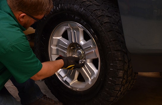 Chris from O’Reilly Auto Parts securing the wheel on the Chevy Silverado